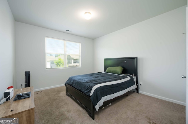 bedroom with visible vents, carpet flooring, and baseboards