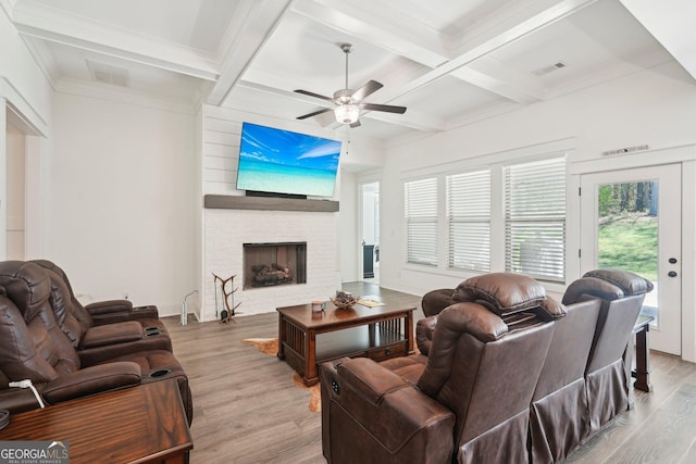 living area featuring ceiling fan, coffered ceiling, beam ceiling, and wood finished floors