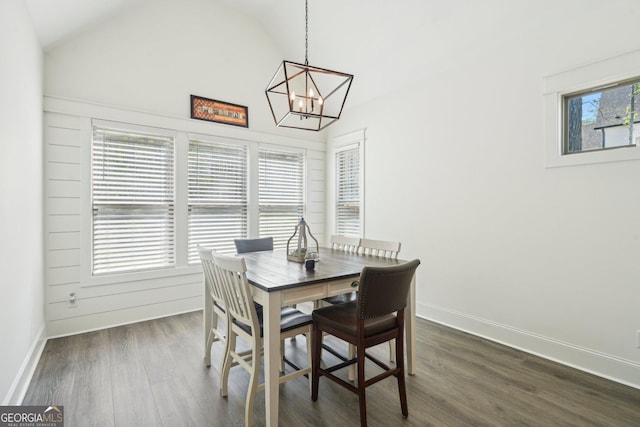 dining room featuring baseboards, an inviting chandelier, high vaulted ceiling, and dark wood finished floors