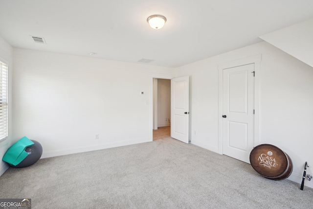 additional living space with baseboards, carpet flooring, and visible vents