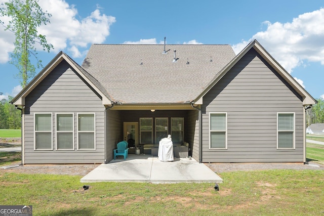 back of property with a lawn and a patio area