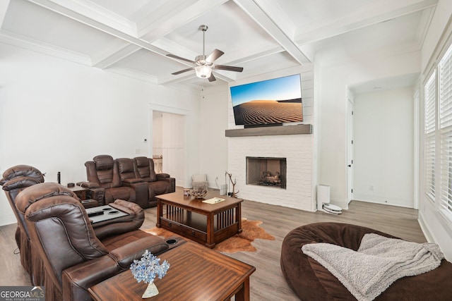 living room with coffered ceiling, a ceiling fan, wood finished floors, and beamed ceiling