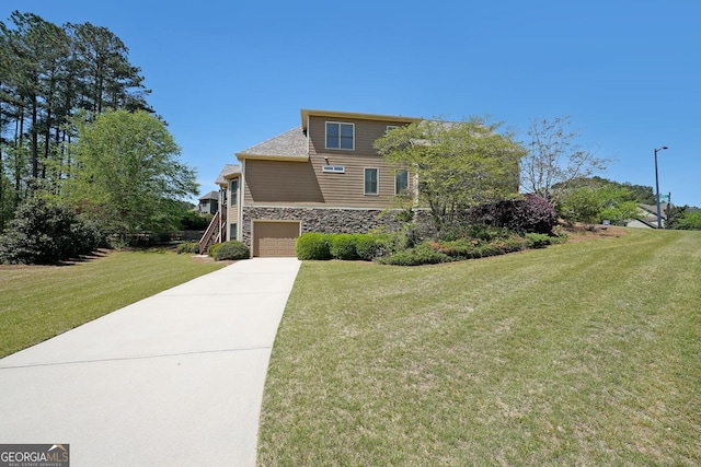 15 Boxelder Ct, Dallas, GA 30132 - view of front facade with a front lawn, stone siding, concrete driveway, a garage, and stairway