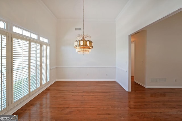 15 Boxelder Ct, Dallas, GA 30132 - unfurnished dining area with wood finished floors, visible vents, an inviting chandelier, and crown molding