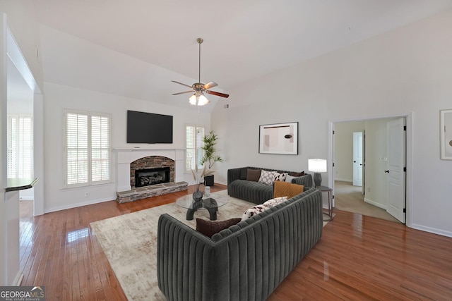 15 Boxelder Ct, Dallas, GA 30132 - living room featuring wood finished floors, baseboards, a fireplace, high vaulted ceiling, and ceiling fan
