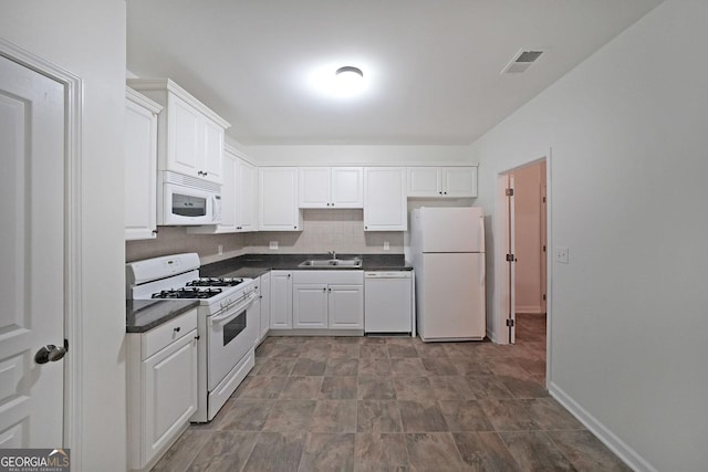 15 Boxelder Ct, Dallas, GA 30132 - kitchen with dark countertops, a sink, white appliances, white cabinets, and visible vents