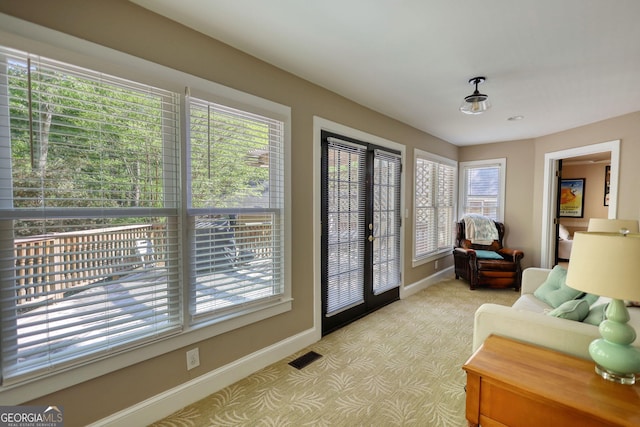 4157 Town Branch Ct SW, Covington, GA 30014 - doorway with a healthy amount of sunlight, baseboards, and light carpet