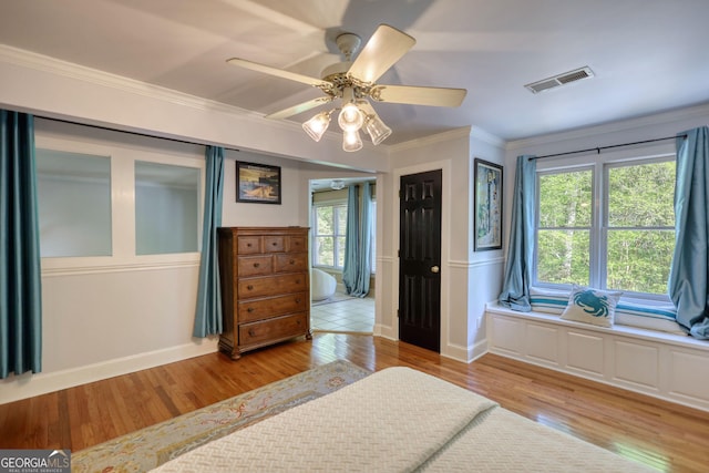 4157 Town Branch Ct SW, Covington, GA 30014 - bedroom with visible vents, crown molding, baseboards, ceiling fan, and light wood-style flooring