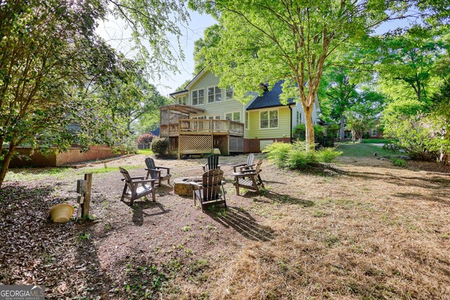 4157 Town Branch Ct SW, Covington, GA 30014 - view of yard with a wooden deck and a fire pit