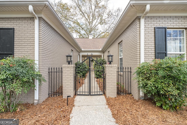 10 Rivermont Dr SW, Rome, GA 30165 - view of exterior entry with brick siding, fence, and a gate