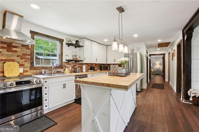 1060 Stephen St, Greensboro, GA 30642 - kitchen featuring stainless steel appliances, wall chimney exhaust hood, butcher block countertops, open shelves, and white cabinets
