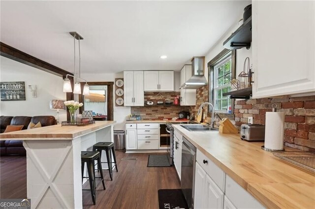 1060 Stephen St, Greensboro, GA 30642 - kitchen featuring wall chimney range hood, butcher block countertops, a breakfast bar, dishwasher, and white cabinetry