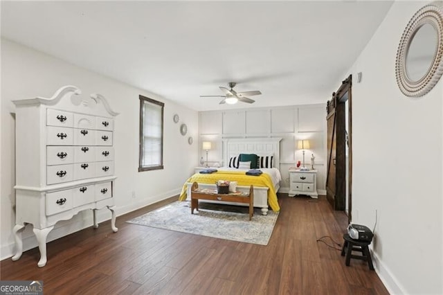 1060 Stephen St, Greensboro, GA 30642 - bedroom with dark wood-style floors, ceiling fan, and a barn door