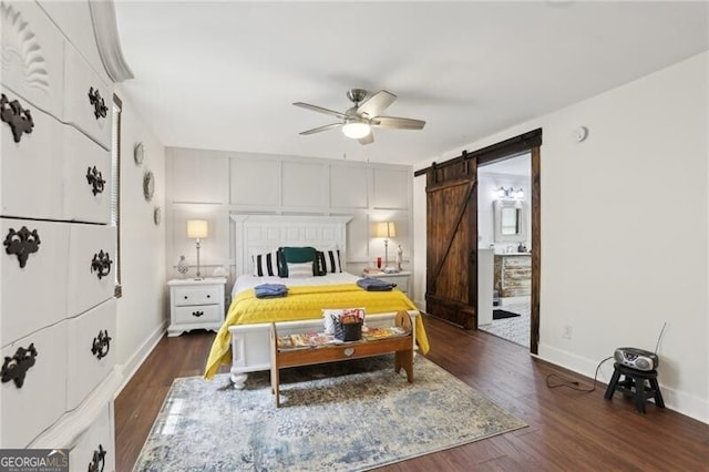 1060 Stephen St, Greensboro, GA 30642 - bedroom featuring a barn door, dark wood-type flooring, and ceiling fan