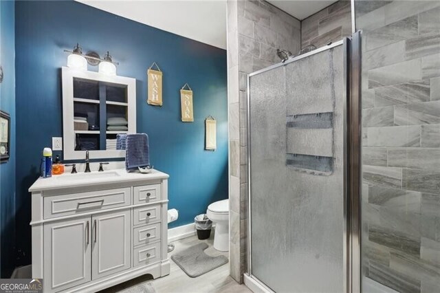 1060 Stephen St, Greensboro, GA 30642 - full bath featuring vanity, a shower stall, and wood finished floors