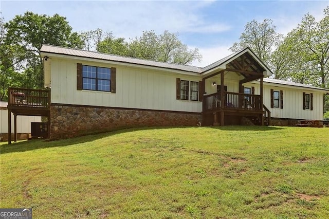 1060 Stephen St, Greensboro, GA 30642 - view of front facade with a wooden deck, a front lawn, and a metal roof