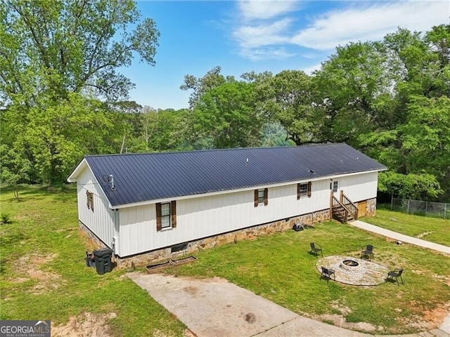 1060 Stephen St, Greensboro, GA 30642 - rear view of property featuring an outdoor fire pit and a metal roof