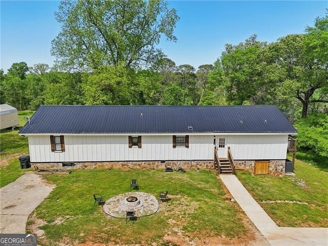 1060 Stephen St, Greensboro, GA 30642 - view of front of home with a front yard, a fire pit, a metal roof, and crawl space