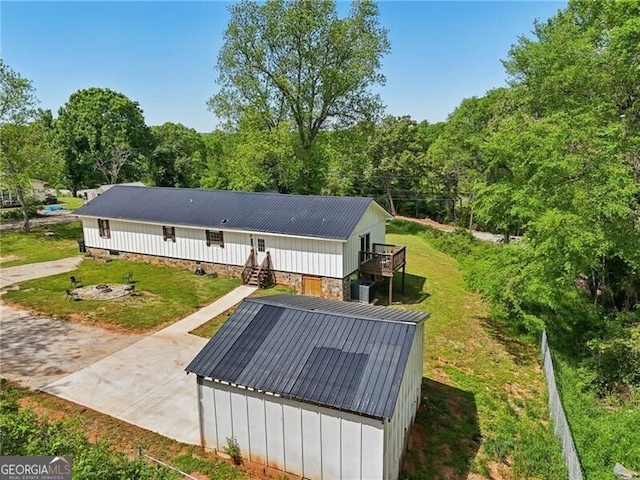 1060 Stephen St, Greensboro, GA 30642 - rear view of property featuring a wooden deck, a metal roof, and a yard