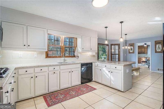 kitchen featuring a peninsula, a textured ceiling, tasteful backsplash, a sink, and dishwasher