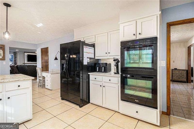 kitchen with white cabinetry, a textured ceiling, light tile patterned floors, and black appliances