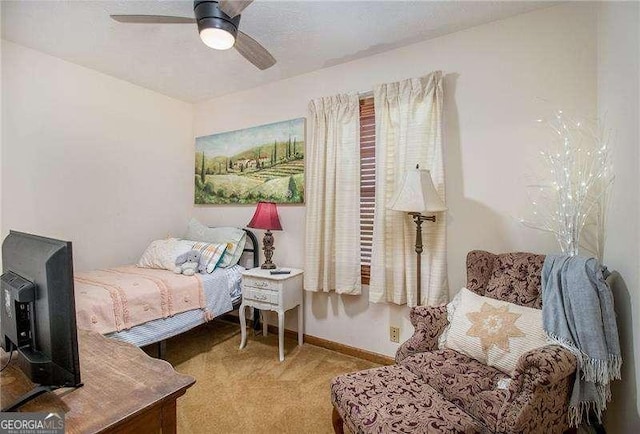 carpeted bedroom featuring baseboards and a ceiling fan