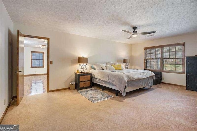 bedroom featuring baseboards, light colored carpet, and multiple windows