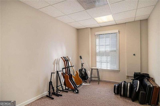 miscellaneous room with carpet floors, a paneled ceiling, and baseboards