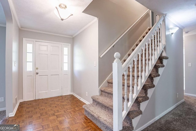 foyer entrance featuring stairway, baseboards, and ornamental molding
