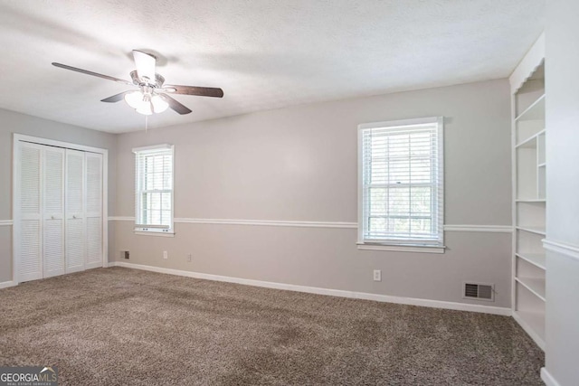 unfurnished bedroom with baseboards, a closet, visible vents, and carpet