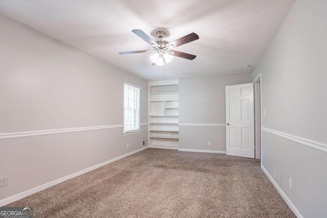 unfurnished bedroom with carpet floors, a ceiling fan, and baseboards