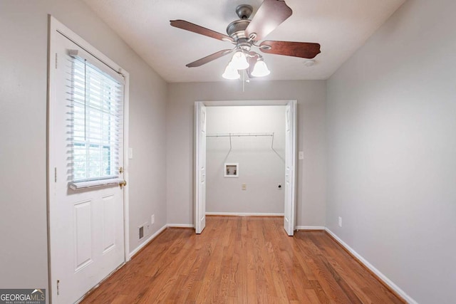 entryway with ceiling fan, baseboards, and light wood-style floors