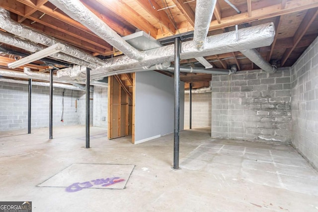 unfinished basement with concrete block wall