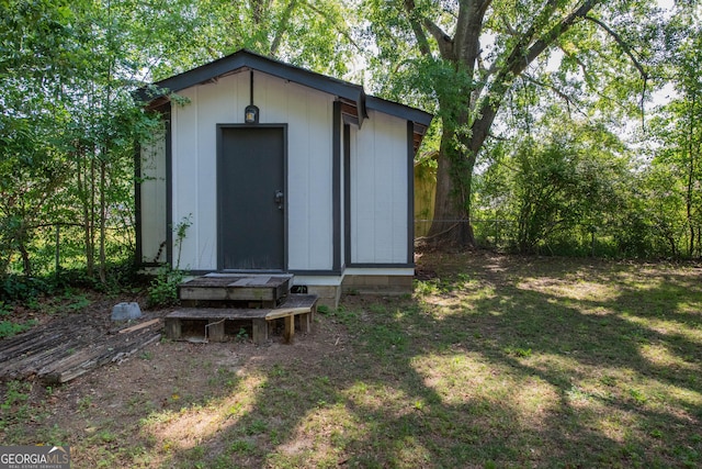 view of shed featuring fence
