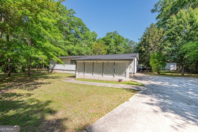 view of community featuring driveway and a yard