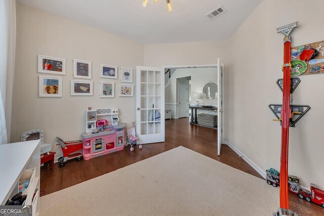 213 Roseman Way, Woodstock, GA 30188 - game room with french doors, wood finished floors, and baseboards
