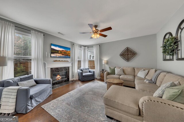213 Roseman Way, Woodstock, GA 30188 - living area with ceiling fan, a premium fireplace, and wood finished floors