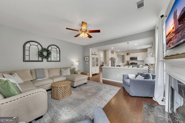 213 Roseman Way, Woodstock, GA 30188 - living area featuring dark wood-style floors, ceiling fan, a fireplace, recessed lighting, and baseboards