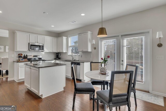 213 Roseman Way, Woodstock, GA 30188 - kitchen with stainless steel appliances, dark countertops, recessed lighting, decorative backsplash, and a kitchen island
