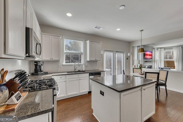 213 Roseman Way, Woodstock, GA 30188 - kitchen featuring appliances with stainless steel finishes, a sink, white cabinetry, backsplash, and dark wood-style flooring