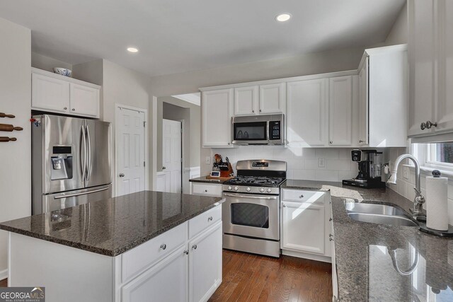 213 Roseman Way, Woodstock, GA 30188 - kitchen featuring appliances with stainless steel finishes, a sink, white cabinetry, dark stone countertops, and recessed lighting