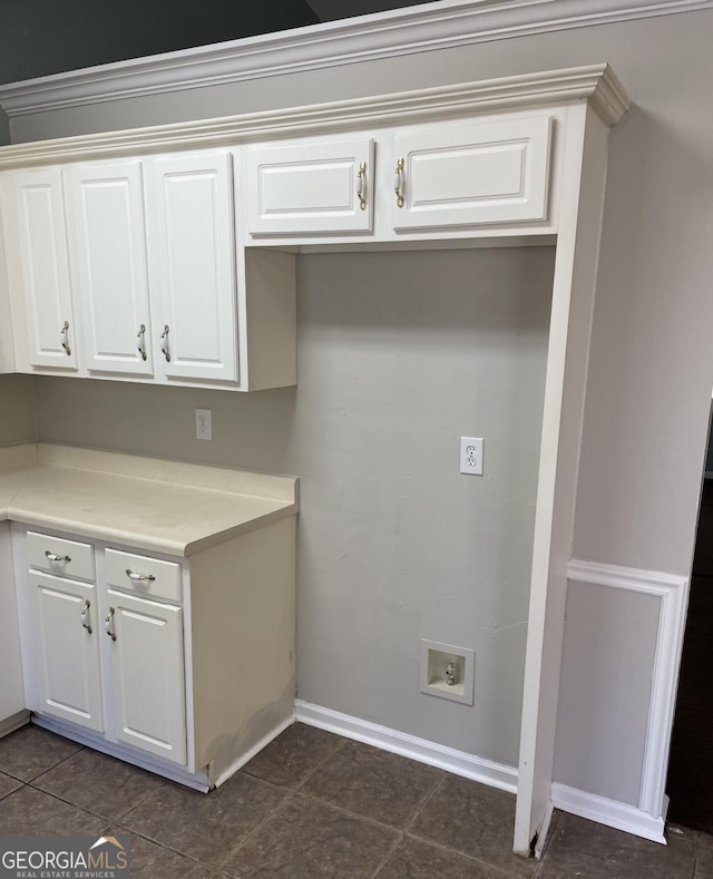 kitchen featuring white cabinets, light countertops, and baseboards