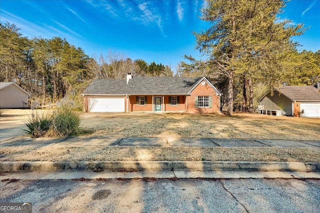 ranch-style home with a garage, driveway, and a porch