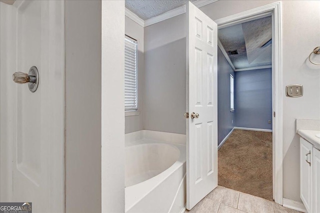 bathroom featuring tile patterned floors, visible vents, vanity, a bath, and crown molding