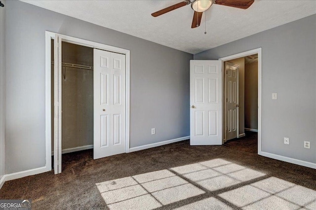 unfurnished bedroom featuring baseboards, carpet flooring, a textured ceiling, and a closet