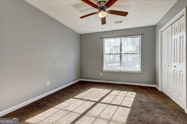 unfurnished bedroom with visible vents, baseboards, carpet flooring, and a textured ceiling