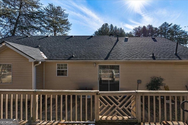 back of property featuring fence and roof with shingles