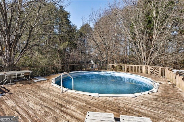 view of pool featuring a wooden deck and a fenced in pool