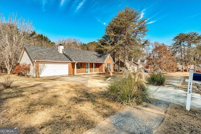 view of front of property with a porch, a chimney, and a garage