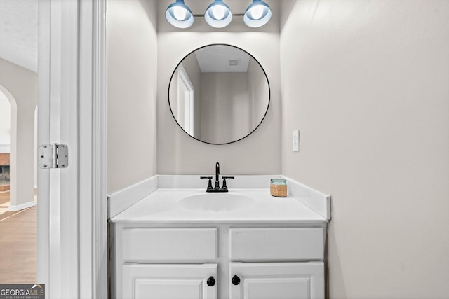 bathroom with wood finished floors and vanity